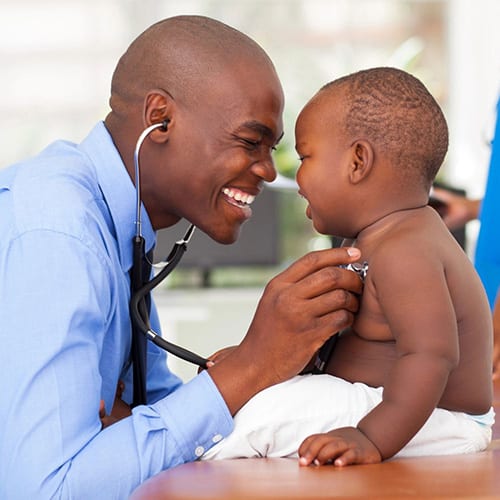 A doctor is examining a baby 's chest.