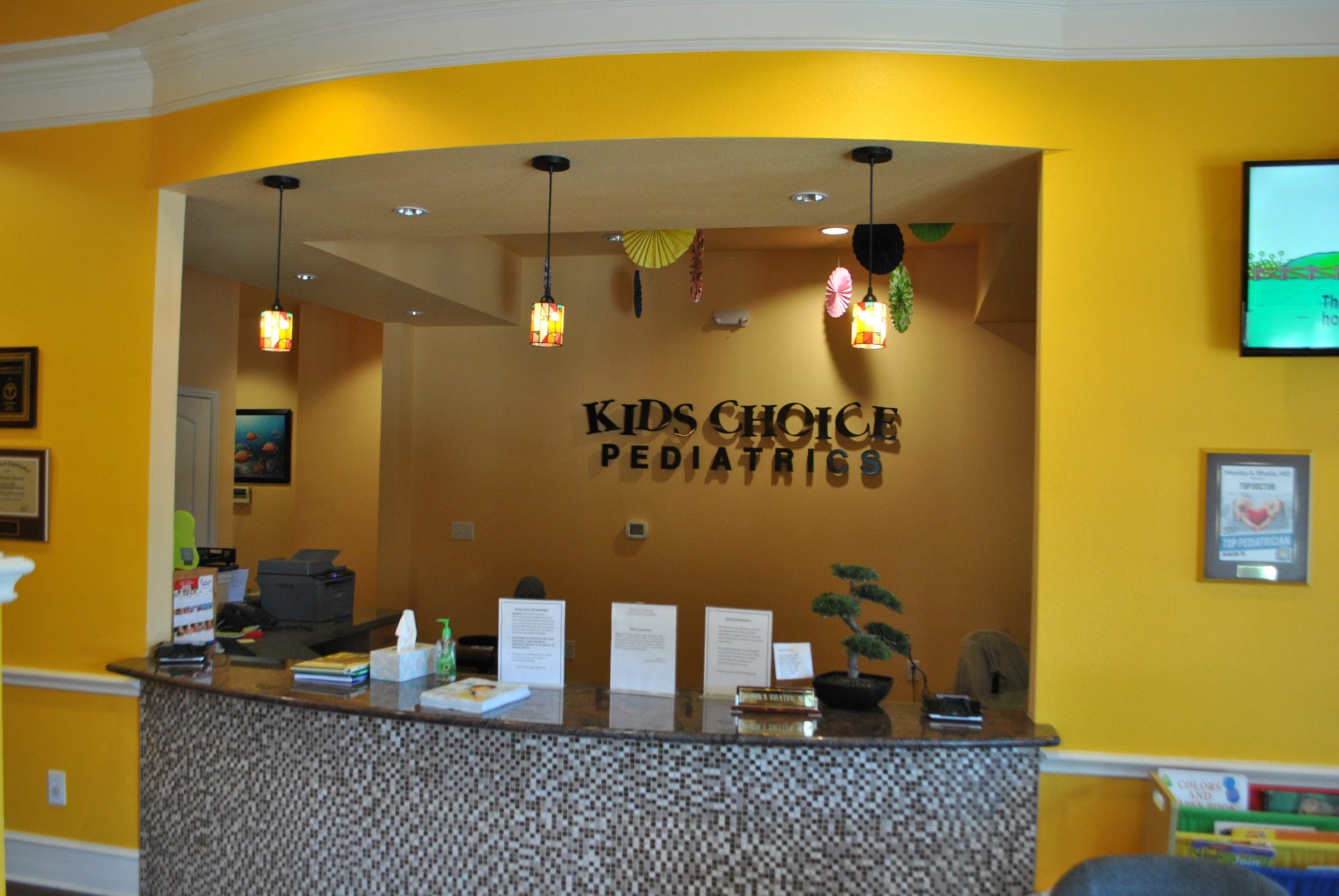 Allen Office Reception A reception desk with the kids choice pediatrics logo on it.
