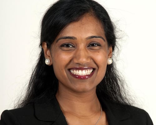 team2 A woman with long hair and white teeth smiling.